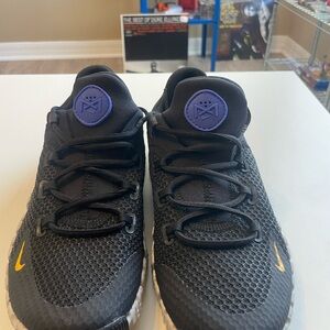 Nike Black Running Shoes with Purple Logo and Yellow Swoosh Accents